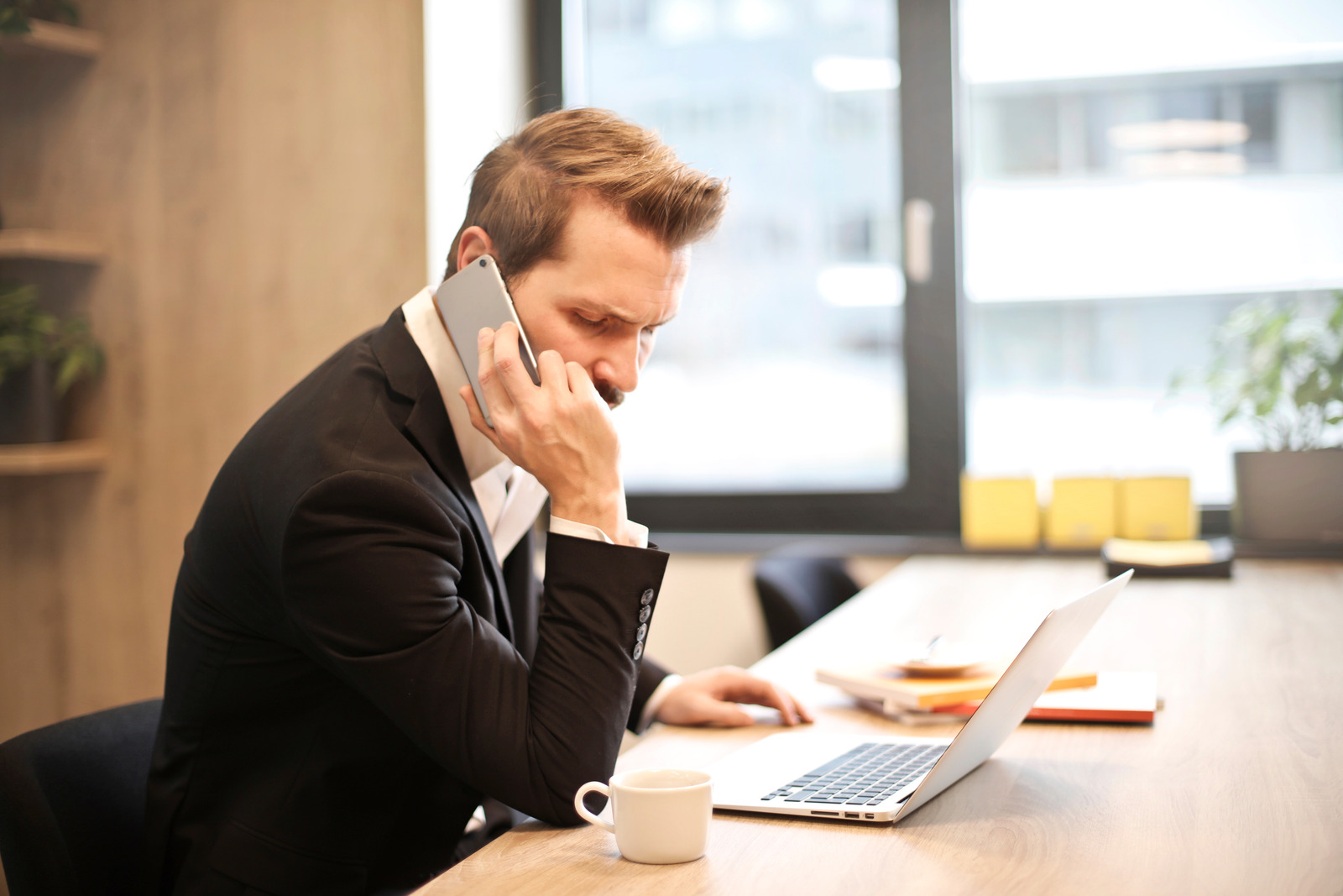 Canva – Man Having a Phone Call In-front of a Laptop