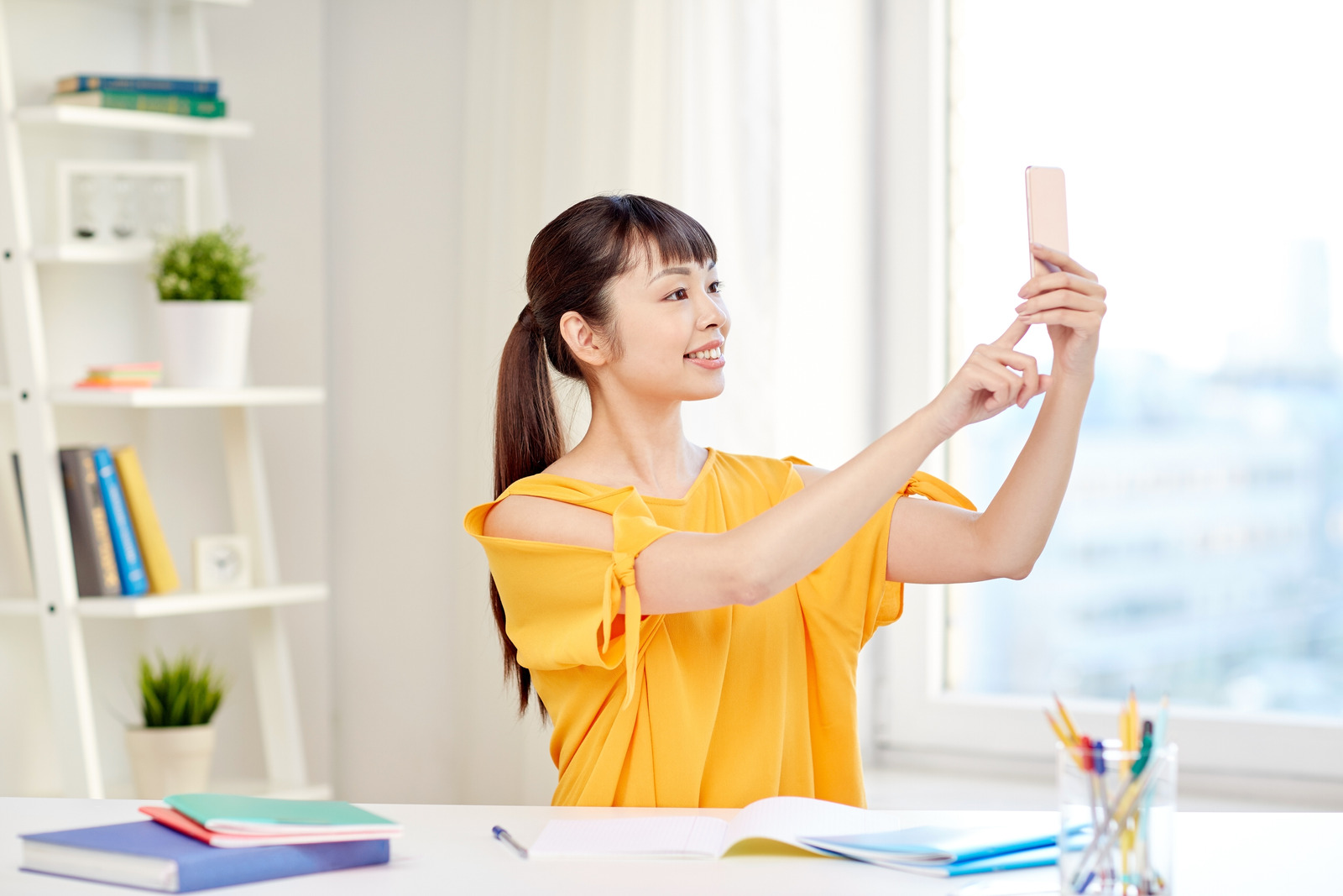 asian woman student taking selfie with smartphone