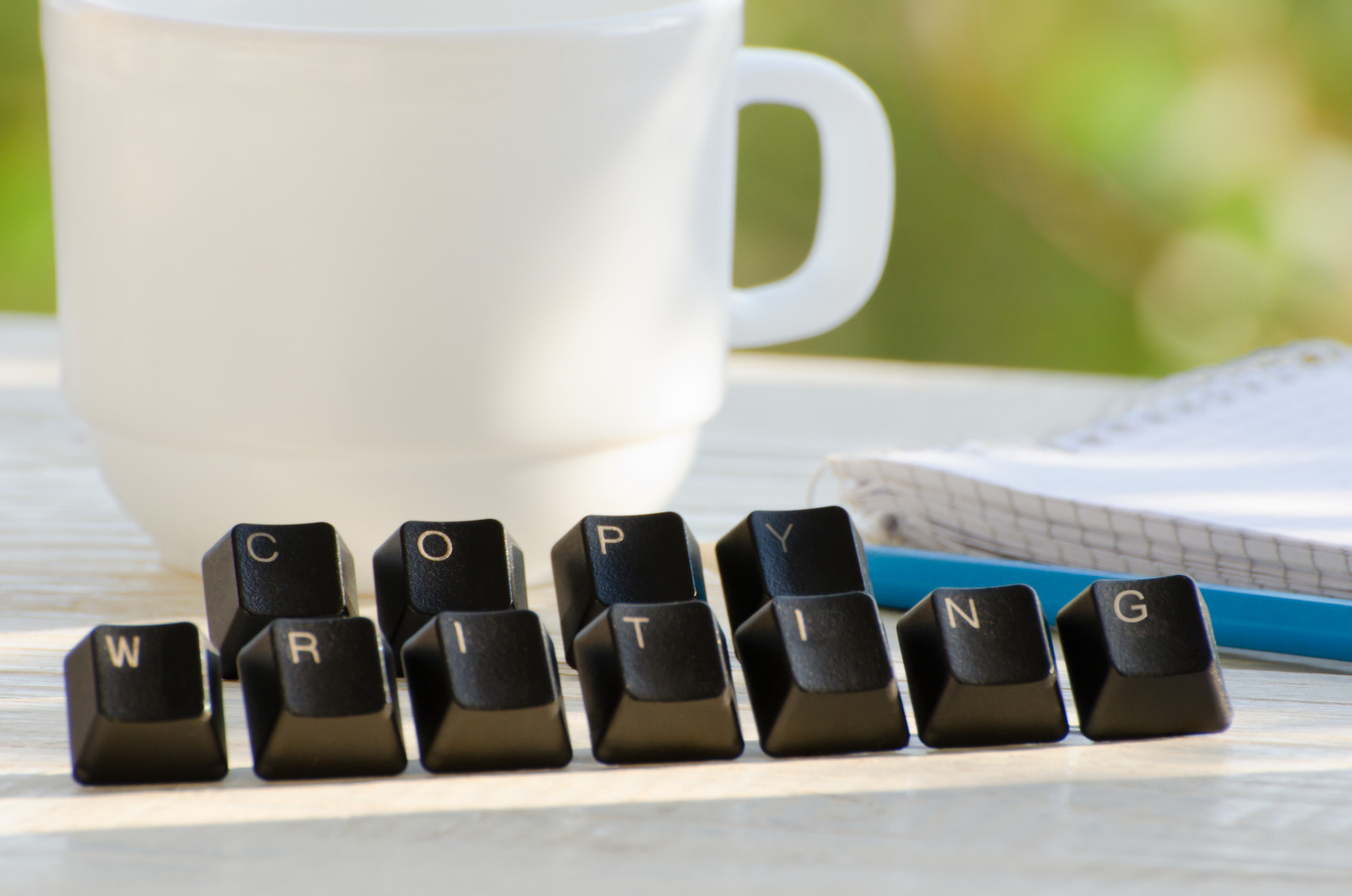 Copywriting Word of keys on a white table, tea mug
