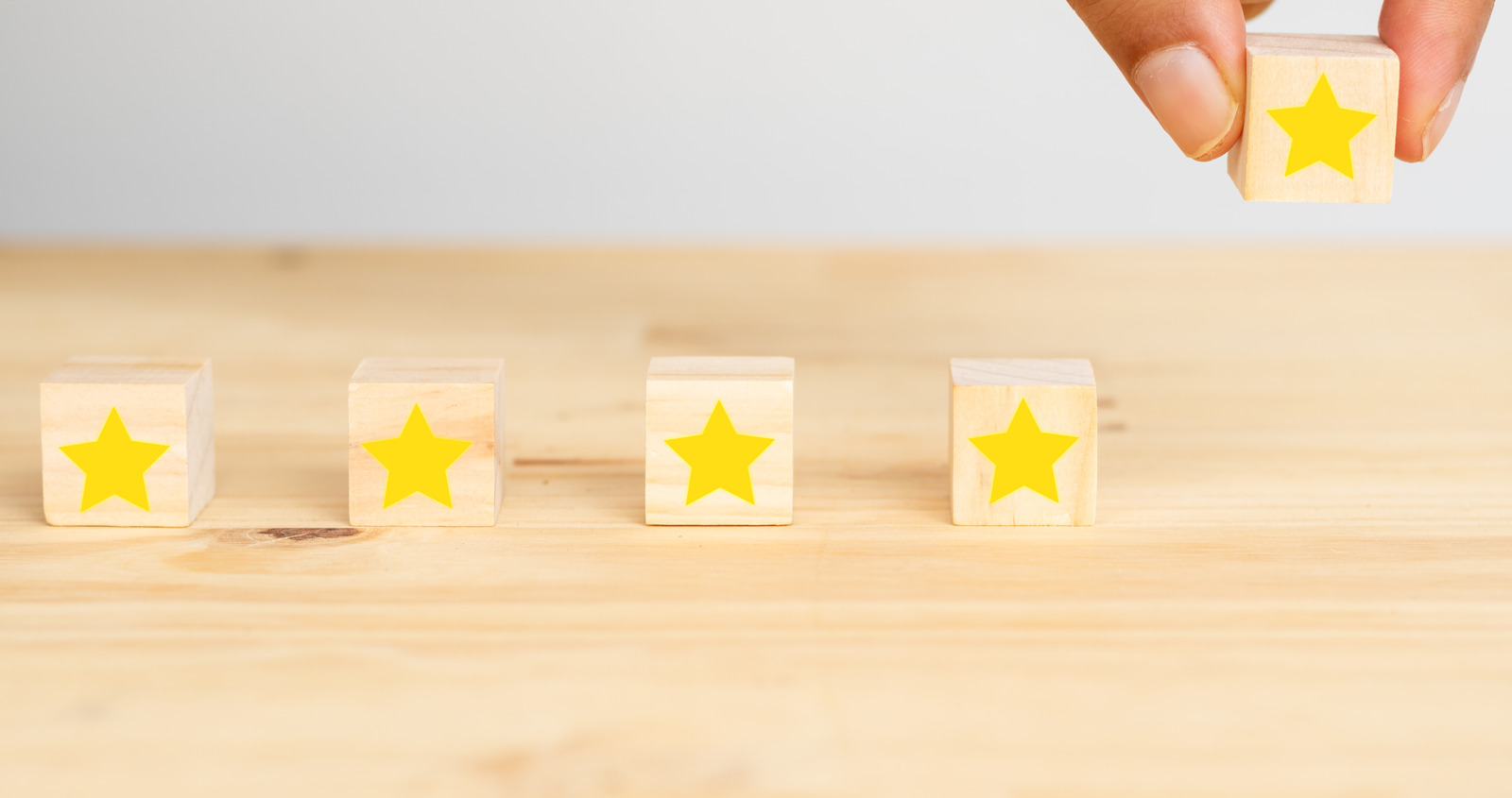 business successful concept, hand man try to put the the fifth star to complete five star rating to the business or service  customer experience , the achievement to complete the goal score rating